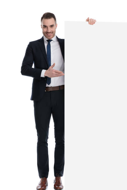 istock Positive businessman smiling and showing empty billboard 1274969882