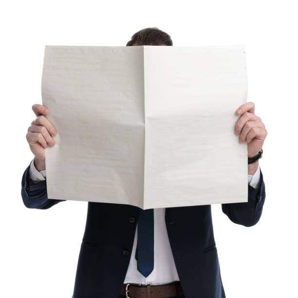 istock Young businessman covering his face with newspaper 1274970524