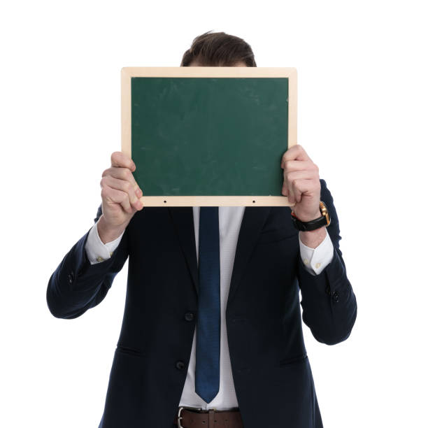 istock Young businessman covering his face with blackboard 1274971277