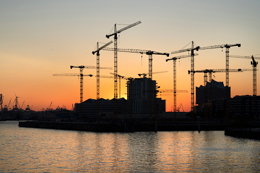 Large construction site in the Hafencity of Hamburg at sunset