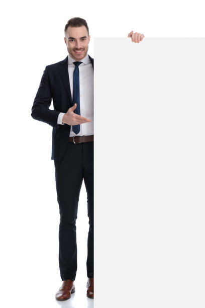 istock Positive businessman presenting empty billboard and smiling 1274975179