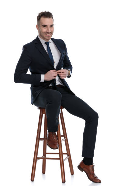 istock Happy businessman smiling and adjusting his jacket 1274978406