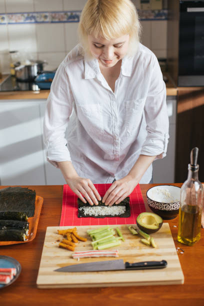 istock Female chef preparing sushi 1274978936