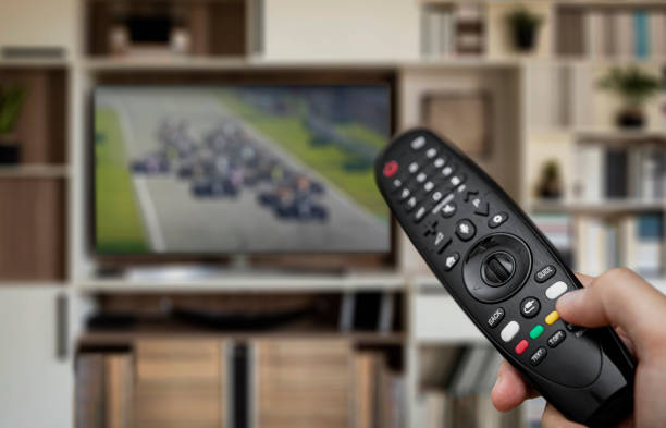 istock Watching motorsports with remote control in hand 1274979230