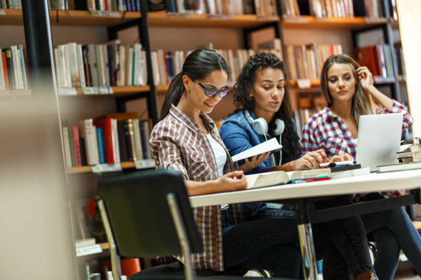 istock Group of female students study in the college library. 1274983657