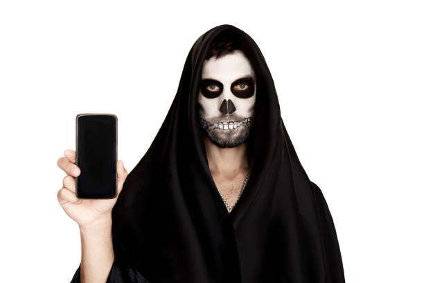 istock A man in Halloween makeup. He holds a phone in his hand. 1274989274