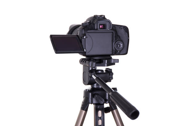 istock photography and videography concept - modern dslr camera with blank screen on tripod isolated on white 1274989331