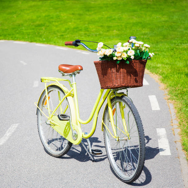 istock yellow vintage bicycle with flowers in wicker basket 1274989341