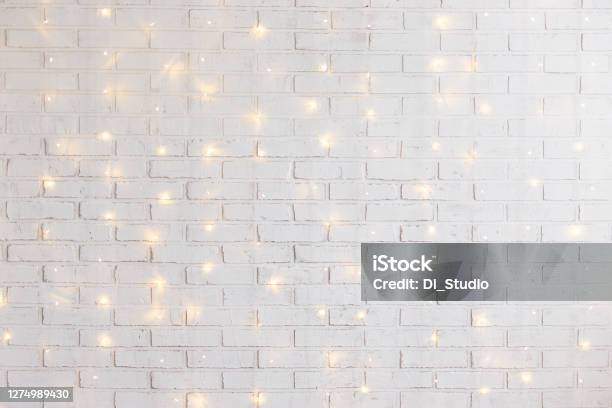 White Brick Wall Background With Shiny Lights Stock Photo - Download Image Now - Christmas, Backgrounds, Wall - Building Feature