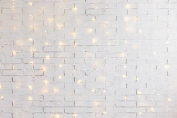 Photo of white brick wall background with shiny lights