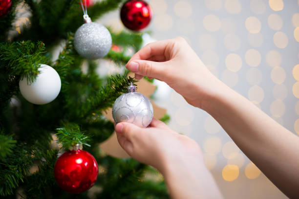 istock holiday background - girl decorating christmas tree 1274989452