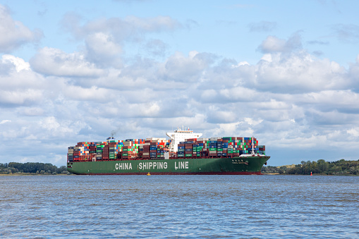 Stade, Germany - September 10, 2019: Ultra-large container ship CSCL Mars on Elbe river heading to Hamburg.