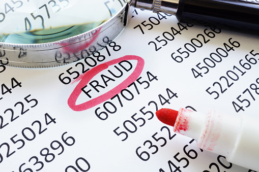 Fraud underlined word and financial data for the business audit.