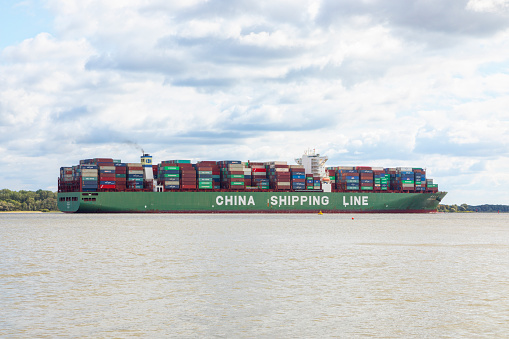 Stade, Germany - September 10, 2019: Ultra-large container ship CSCL Mars on Elbe river heading to Hamburg.