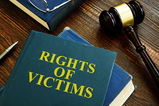 Rights of victims book on wooden surface.
