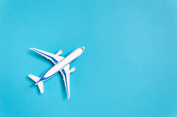 istock White airplane on blue background with copy space for text. Minimal travel concept 1274995663