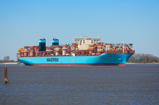 Stade, Germany - April 22, 2020: Container ship MORTEN MÆRSK on Elbe river heading to Hamburg. It is one of 31 Maersk Triple E-class container ships that comprise a family of very large container ships of more than 18,000 TEU.