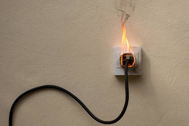 istock On fire electric wire plug Receptacle on the concrete wall exposed concrete background with copy space 1274999673