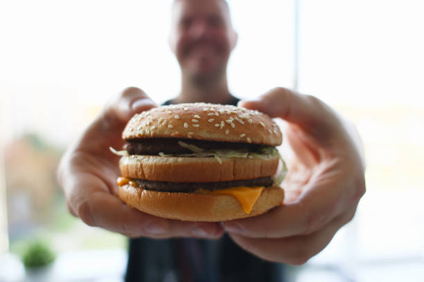 istock Focused photo on burger that being in male hands 1275013039