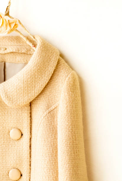 istock white wool short coat hanging on clothes hanger on white background 1275014382