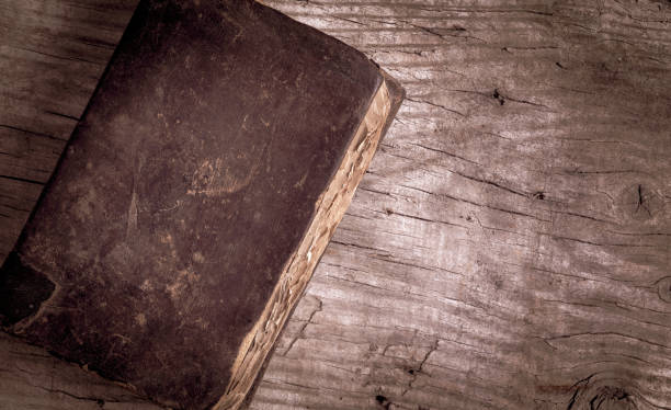 istock Weathered ancient book with leather cover on wooden table. Top view, copy space for text. 1275024860