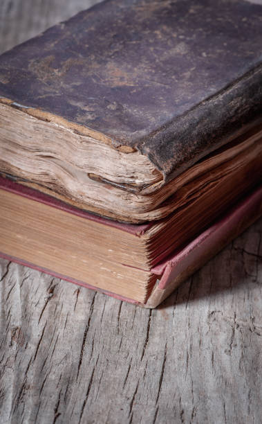istock Ancient weathered books on wooden table, close-up 1275025794