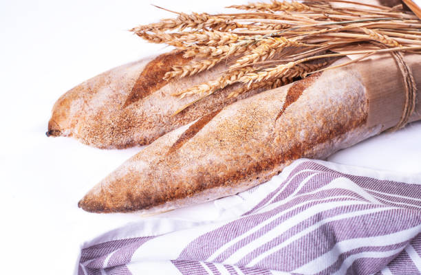 istock Freshly baked baguettes isolated on white background. 1275029015