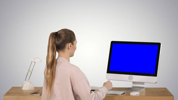 istock Attractive casual businesswoman working at office using pc Blue 1275039421