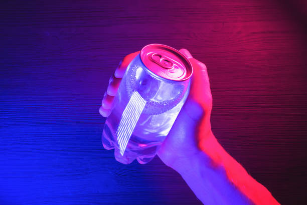 Energy drink. A transparent soda can in the neon lights on the black table background. energy drink photos stock pictures, royalty-free photos & images