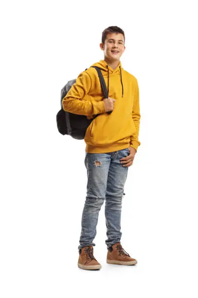 Photo of Male teenage student in a yellow hoodie and a backpack smiling at the camera