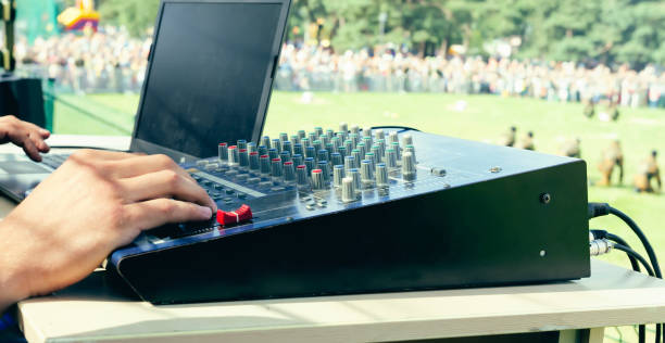istock Specialist works with sound mixing console and computer, hand close-up 1275057101