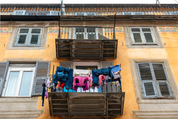 Laundry drying on the balcony of an old building in Rome, Italy.