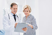 Doctor consulting patient in hospital hallway