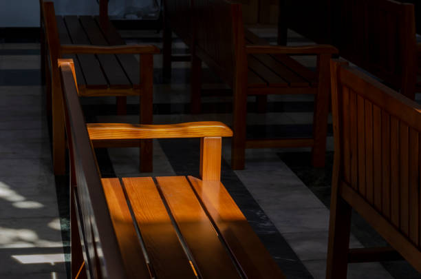 istock Rows of empty pews inside a small church. 1275072880