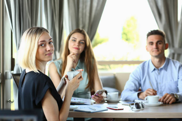 istock Friendly colleagues sitting together in the cafe 1275080962