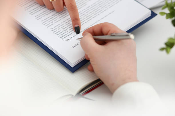 istock Close up of female hand that pointing at document 1275081089