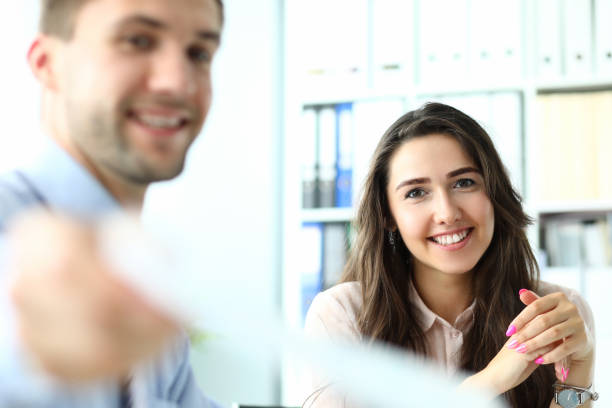 istock Joyful young colleagues working together at their project 1275081408