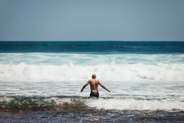 istock Wading Into The Sea 1275083629