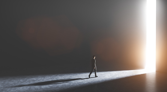 Businessman walking towards an open big gate of light. Concept of hope, new better world, bright future. 3D illustration