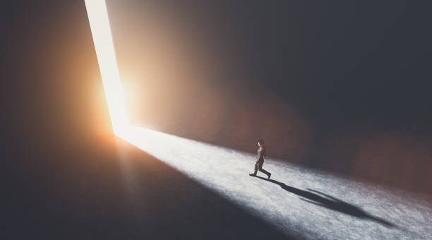 istock Businessman walking towards an open gate of light. 1275093138