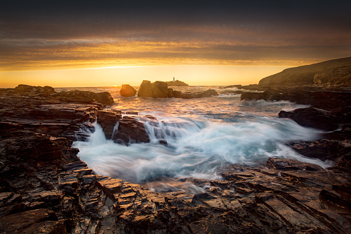 Dramatic seascape image , as waves crash over the rocks at Godrevy on the North Cornish Coast.