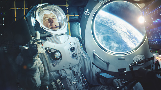 Astronaut Sitting Inside a Space Rocket During Takeoff. Successful Rocket Launch Sending Spaceship into Space. Cosmonaut Experiencing G-Force and Showing Thumbs Up in a Report of his Condition.