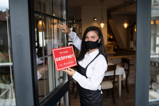 istock Open sign in a small restaurant or cafe after Coronavirus pandemic 1275108439