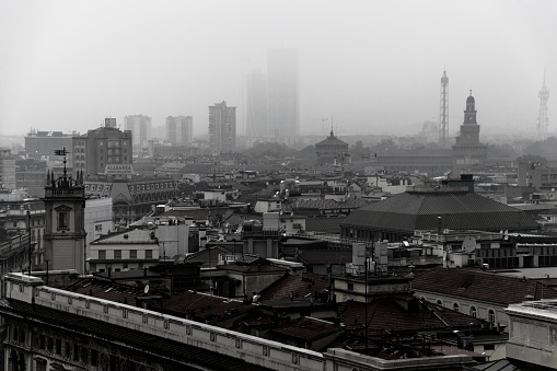 Milan, Italy - October 19, 2016: A high angle view of Milan's city skyline on a foggy autumn morning. Milan (Italian: Milano) is a city in northern Italy, capital of Lombardy, and the second-most populous city in Italy after Rome. Milan served as the capital of the Western Roman Empire, the Duchy of Milan and the Kingdom of Lombardy–Venetia. The city proper has a population of about 1.4 million while its metropolitan city has 3.26 million inhabitants.