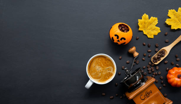 istock halloween decoration with hot coffee and beans on dark background. flat lay. Copy space for text. 1275124756