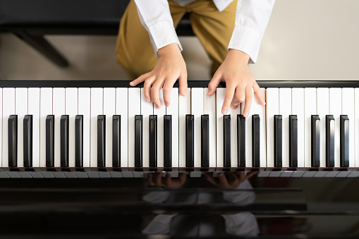 Top view boy hand playing  piano