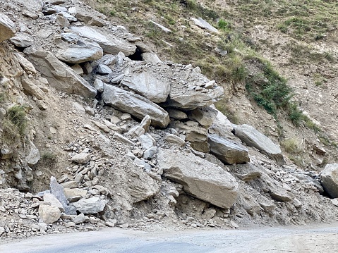 Big stones coming on road due to sliding in hills