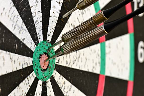 istock Three darts in a target. One in the right center. 1275153452