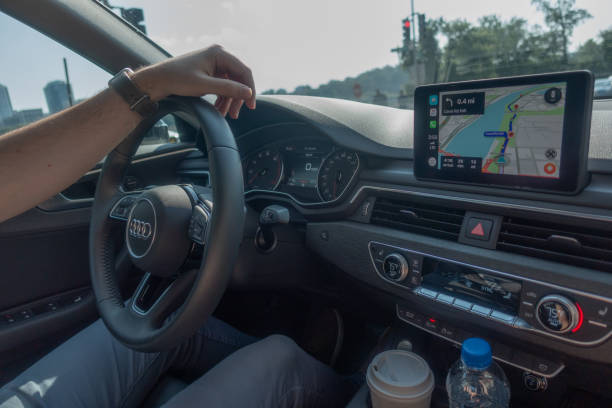 Man driving car while Carplay navigation working. stock photo