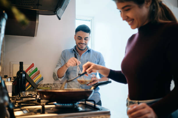 istock Husband And Wife Cooking Together An Omelette For Breakfast 1275167630